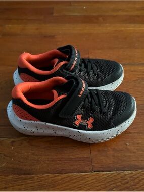 Under Armour Kids Black and Orange Athletic Sneakers with Speckled White Sole